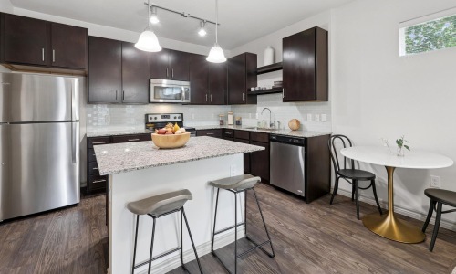 a kitchen with a table and chairs