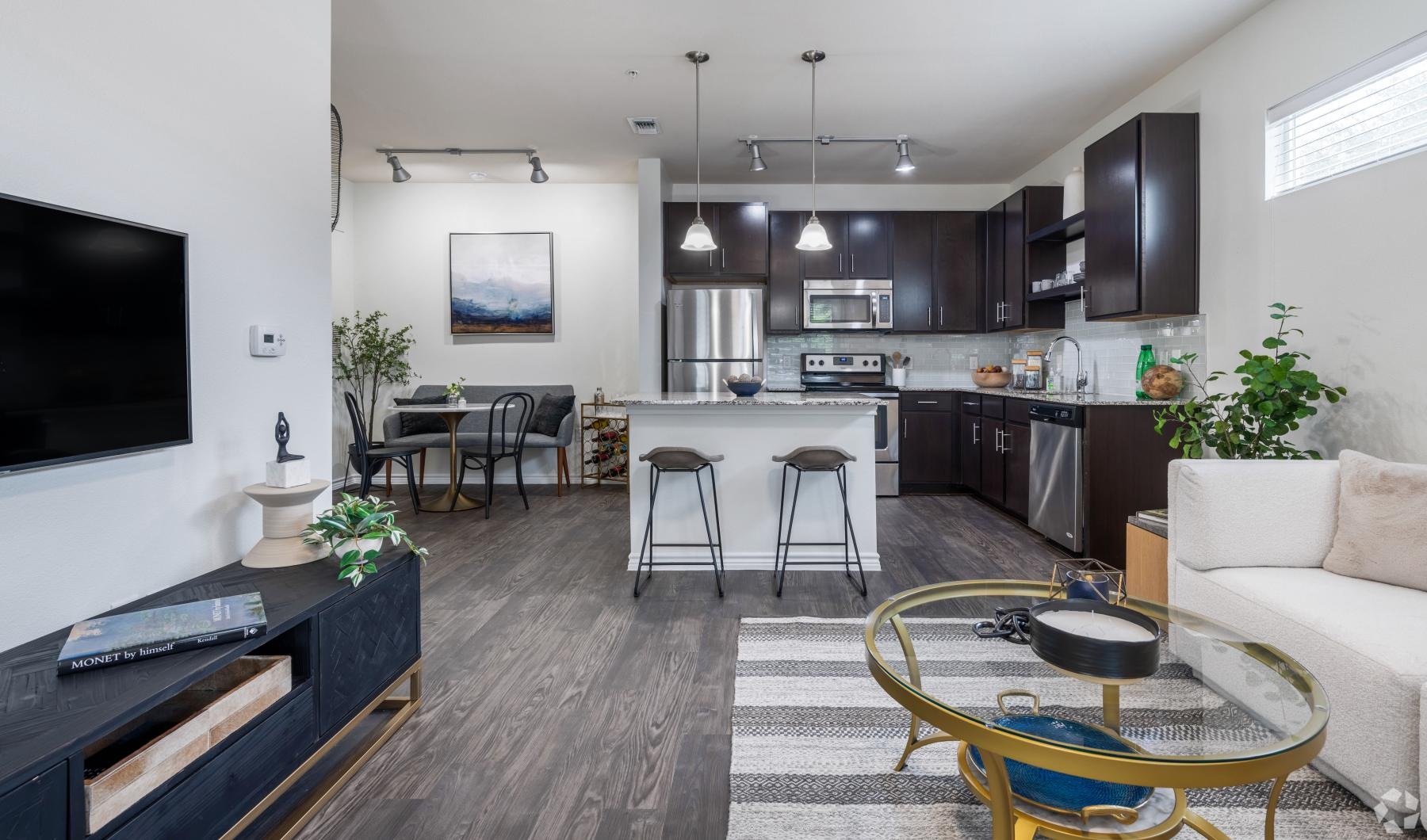 a kitchen with a bar and chairs