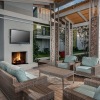 an outdoor patio with a fireplace and media area