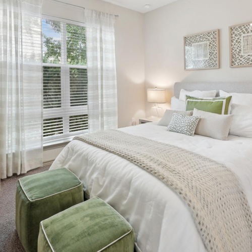 a bedroom with a bed and a fan